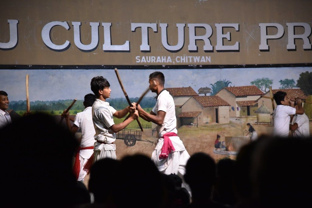 Dancers clash wooden sticks during a traditional Tharu stick dance performance at a cultural center in Sauraha near Chitwan National Park.